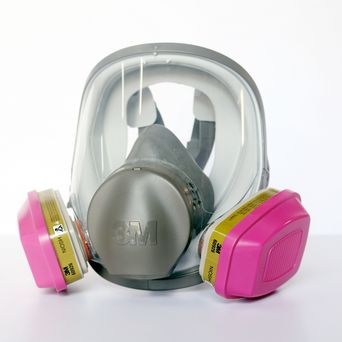 A full-face 3M P100 respirator with pink cartridges to filter organic vapor and acid gas.
